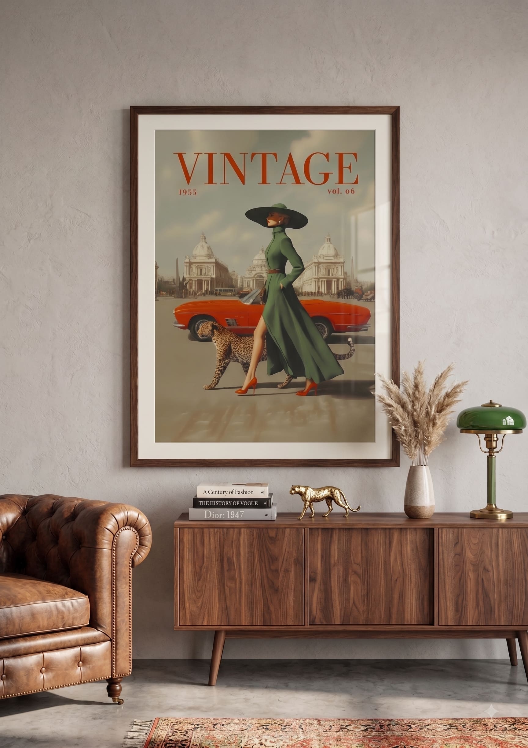 A framed vintage-style poster hangs on a light gray wall above a wooden sideboard in a styled room. The poster features the word 'VINTAGE' at the top, an orange car, a woman in a long green dress and black hat, and a dog.