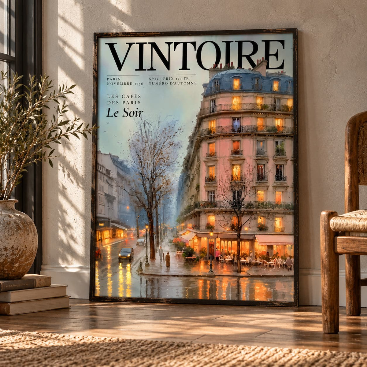 Framed Vintoire Rainy Paris poster leaning on a wooden floor by a sunlit window, with an olive branch in a clay vase and a rush-seat chair.