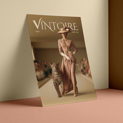 A fashion magazine or poster titled "VINTOIRE" leaning against a beige wall on a dusty pink surface. The cover shows a woman in a long blush pink dress and hat walking with a leopard in a runway setting.