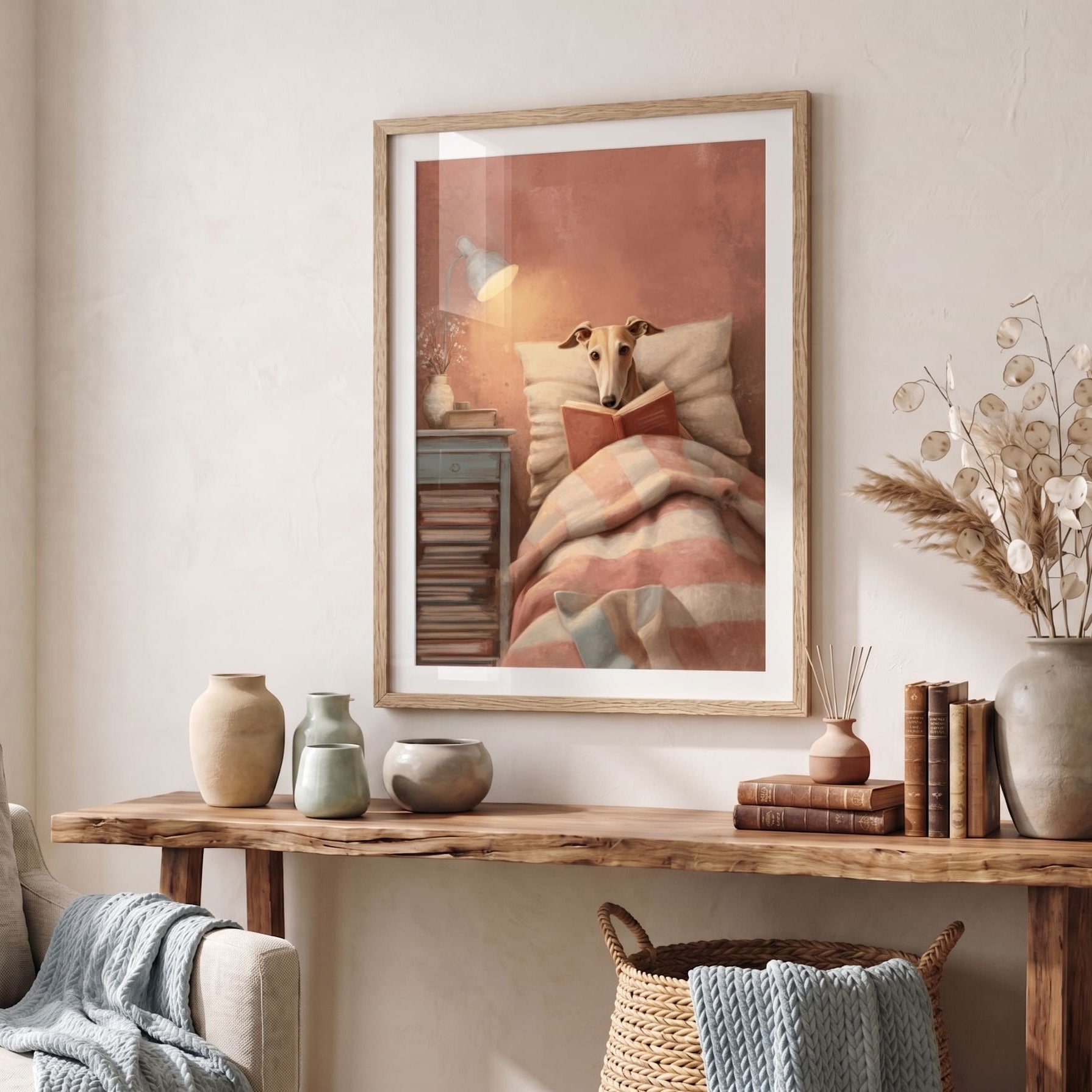 Living room with a wooden console table, framed artwork of a whippet reading in bed, and decorative items.