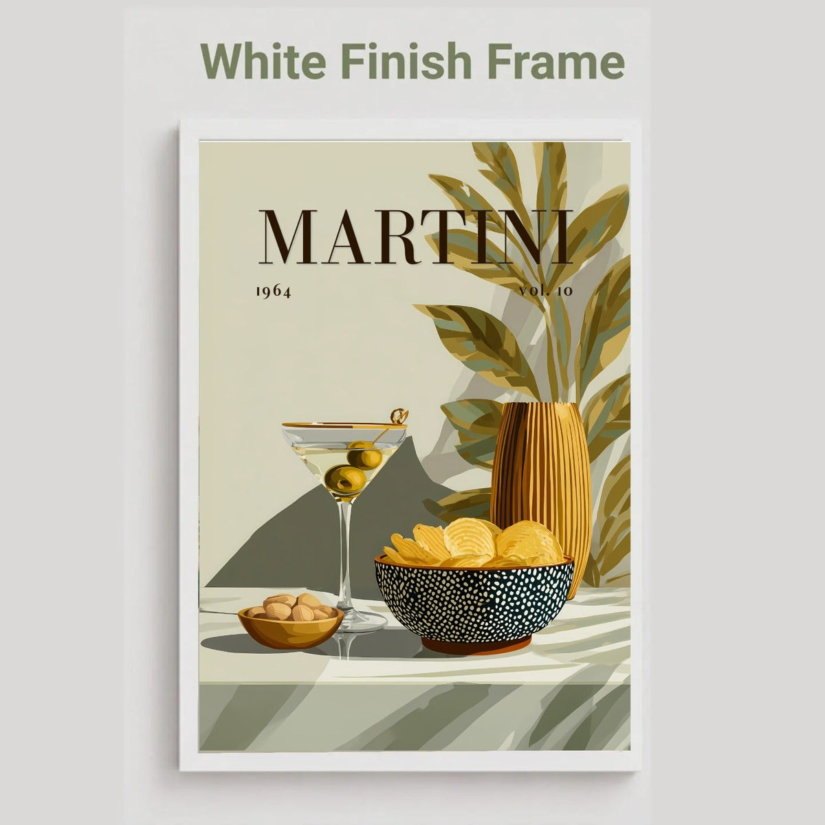 A framed art print featuring a stylized Martini cocktail illustration with olives, lemon slices, and a striped vase on a beige background. The print is shown with a white frame and the text 'White Finish Frame' above it, on a light gray background.