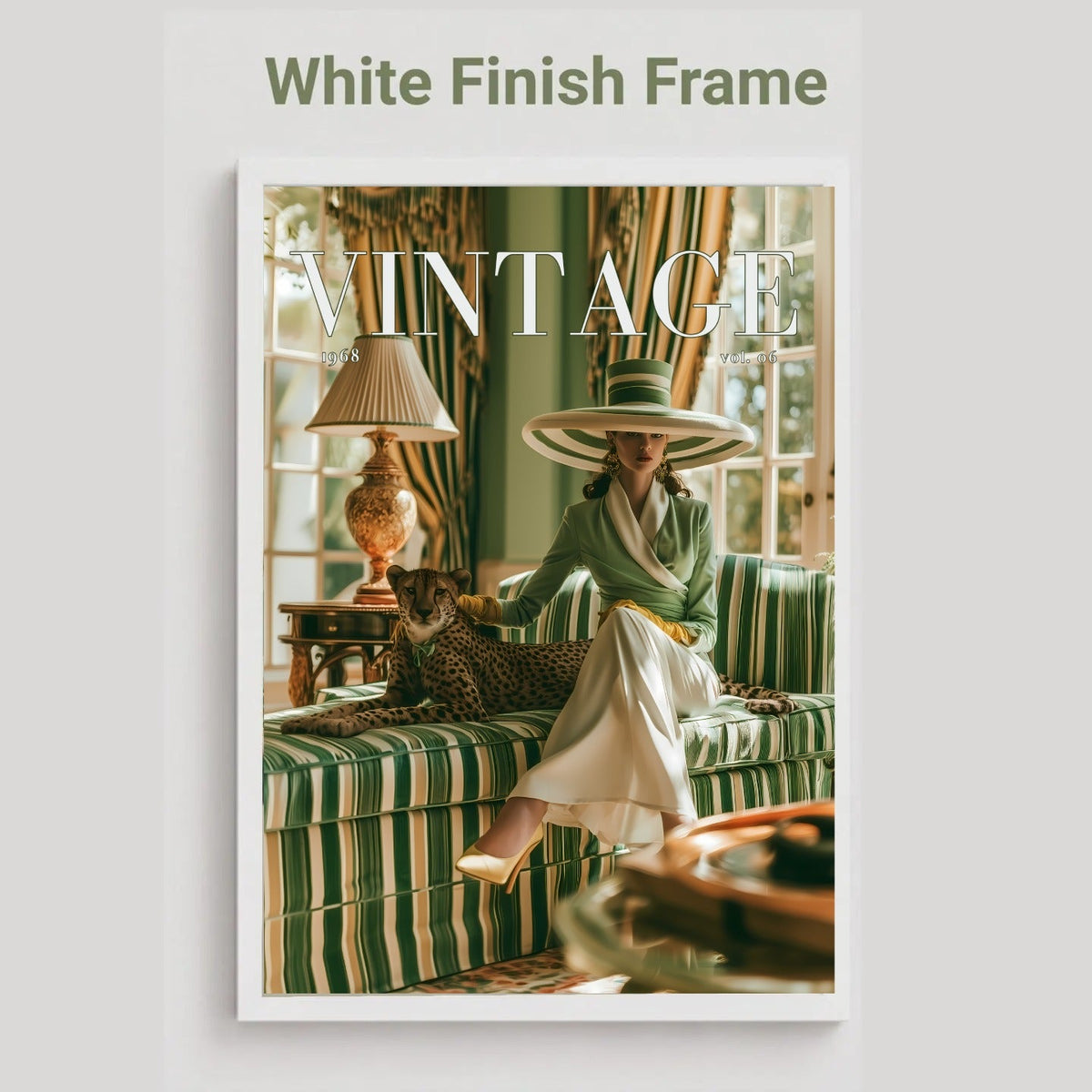 A framed art print featuring a vintage-style photograph of a woman in a green striped dress and wide-brimmed hat sitting on a matching sofa, with a leopard at her side. The print is housed in a white frame, set against a light gray background with the text 'White Finish Frame' above it.