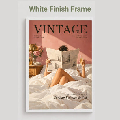 A vintage-style magazine cover mockup with a white frame and the text 'White Finish Frame' above it. The cover shows a woman reading a newspaper in bed against a dusty pink wall, with the title 'VINTAGE' prominently displayed.
