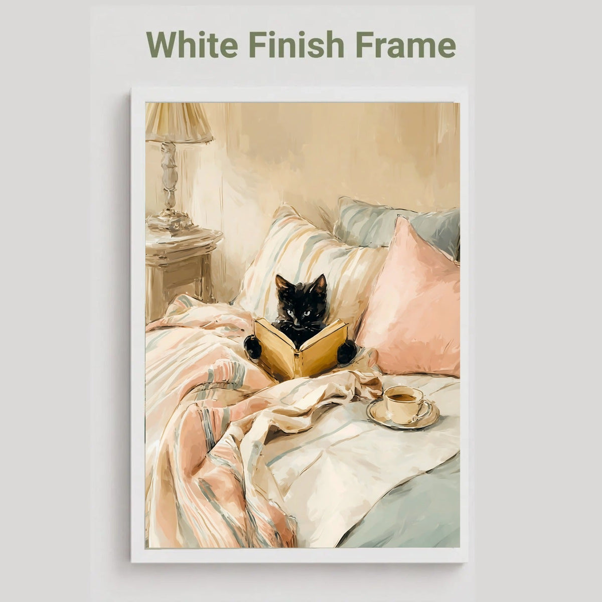 White finish frame option showing the black cat reading a book in bed print in blush pink and cream tones.
