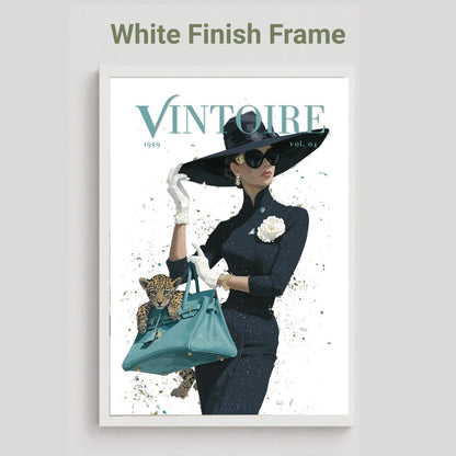 A framed art print featuring a vintage fashion illustration of a woman in a black outfit and wide-brimmed hat, holding a teal handbag with a leopard cub, displayed on a light gray background with the text 'White Finish Frame' above it.