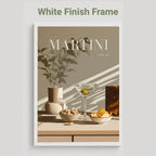 A framed art print featuring a minimalist still life of a martini glass, bowls of snacks, and a vase with leaves under diagonal shadows. The print is presented in a white frame against a light gray background, with the text 'White Finish Frame' at the top.