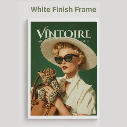 A vintage-style poster or print with a white frame, featuring a woman in a wide-brim hat and sunglasses holding a leopard, with the title 'VINTOIRE' at the top. The image is shown on a light gray background with the text 'White Finish Frame' above it. Retro leopard wall art poster: 1950s woman in cat-eye sunglasses holding a leopard cub, green vintage print for maximalist decor