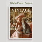 A framed art print featuring a vintage cover design with the title 'VINTAGE' and a woman in a pale pink gown seated beside a leopard, shown against a light gray background with the text 'White Finish Frame' above it.