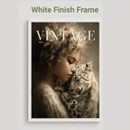 A framed art print featuring a vintage-style portrait of a woman cradling a spotted cat, with the word 'VINTAGE' across the top. The print is shown with a white frame on a light gray background, with the text 'White Finish Frame' above it.