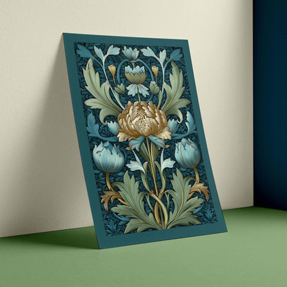 A vertical art print featuring an ornate floral design in teal, blue, beige, and muted green, leaning against a cream wall on a green surface.