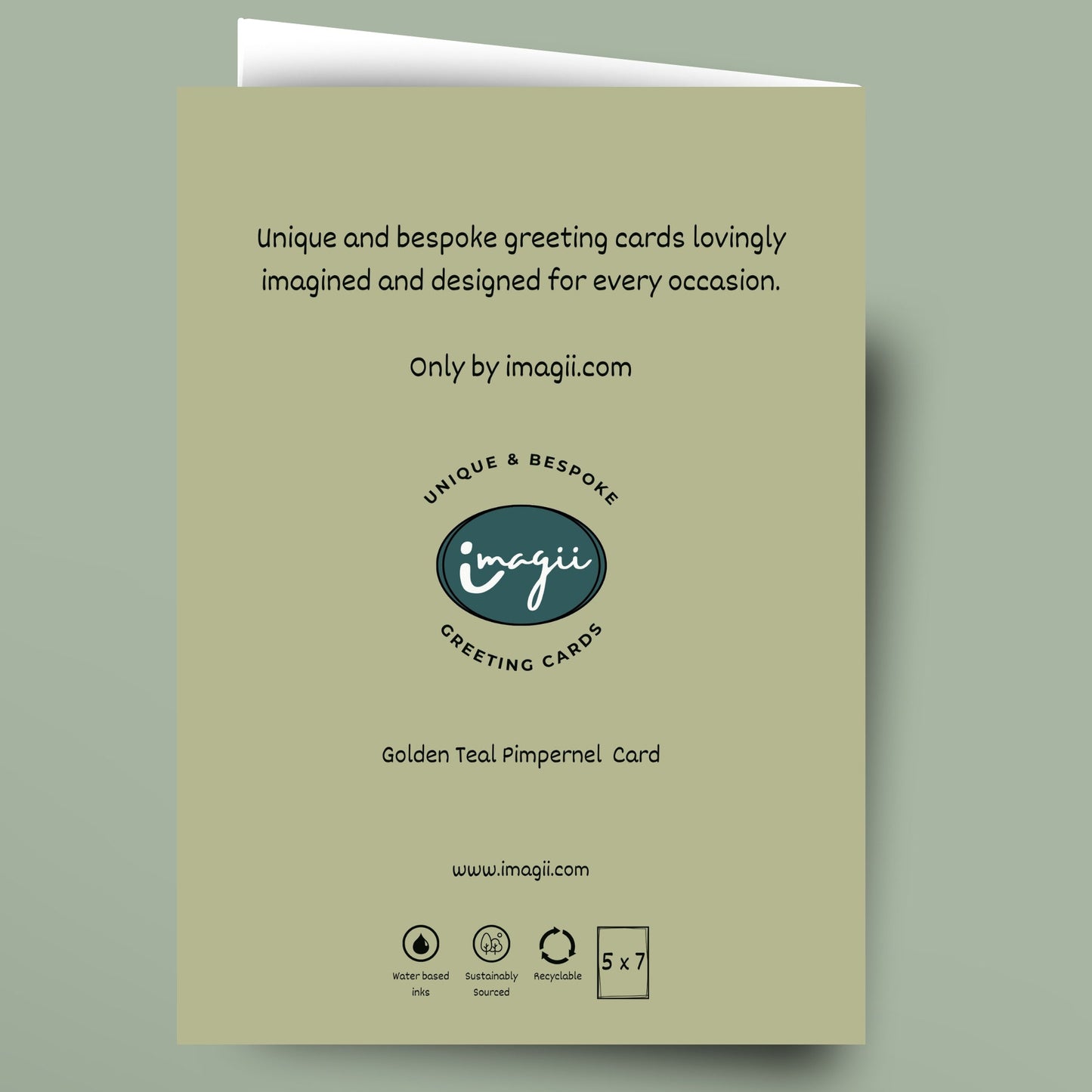 A greeting card shown flat against a muted sage green background. The card is a pale warm beige/olive tone with black text and a central logo reading 'inagi' and 'Greeting Cards.