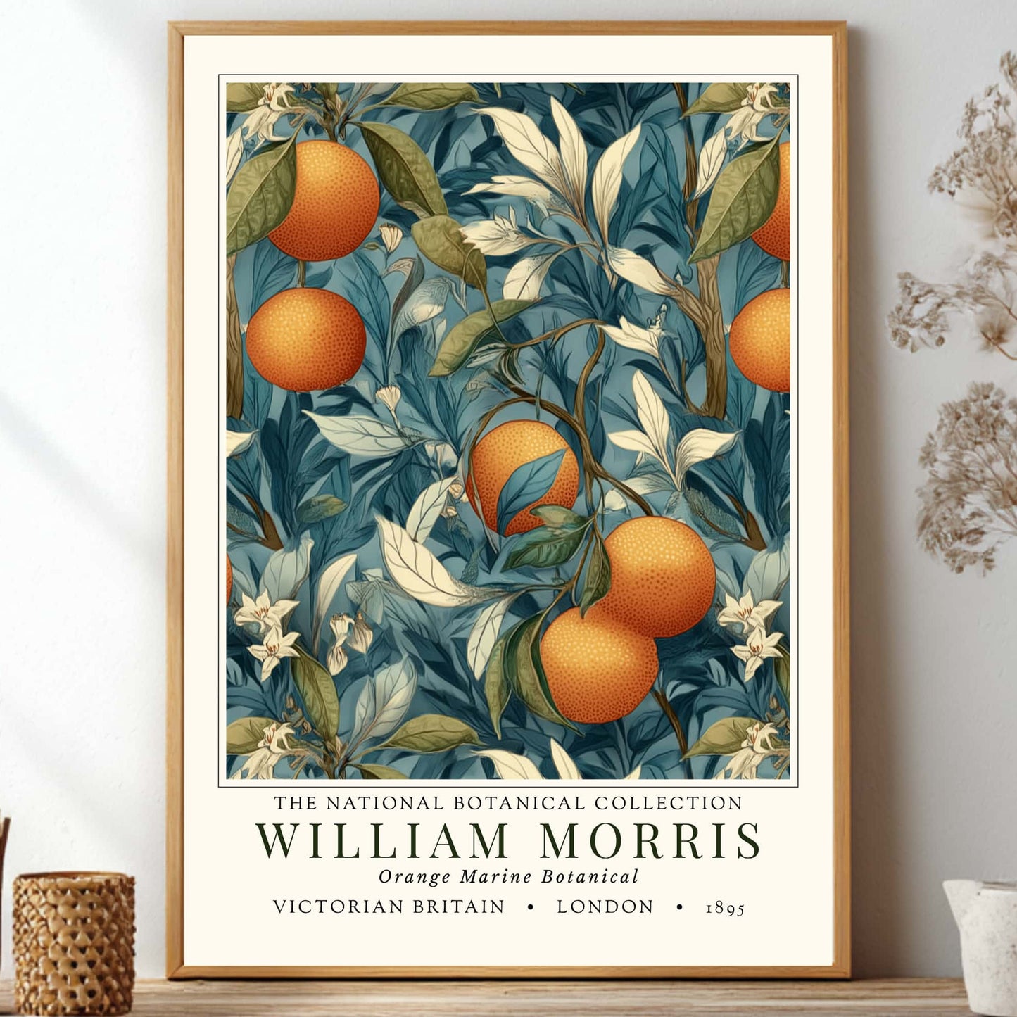 Framed botanical exhibition print by william morris of oranges and leaves on a wall with decorative items.