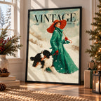A framed vintage-style poster leaning against a wall in a decorated room. The poster shows a woman in a long green coat and red hat walking a black-and-white dog in the snow, with the text 'VINTAGE 1958 vol.