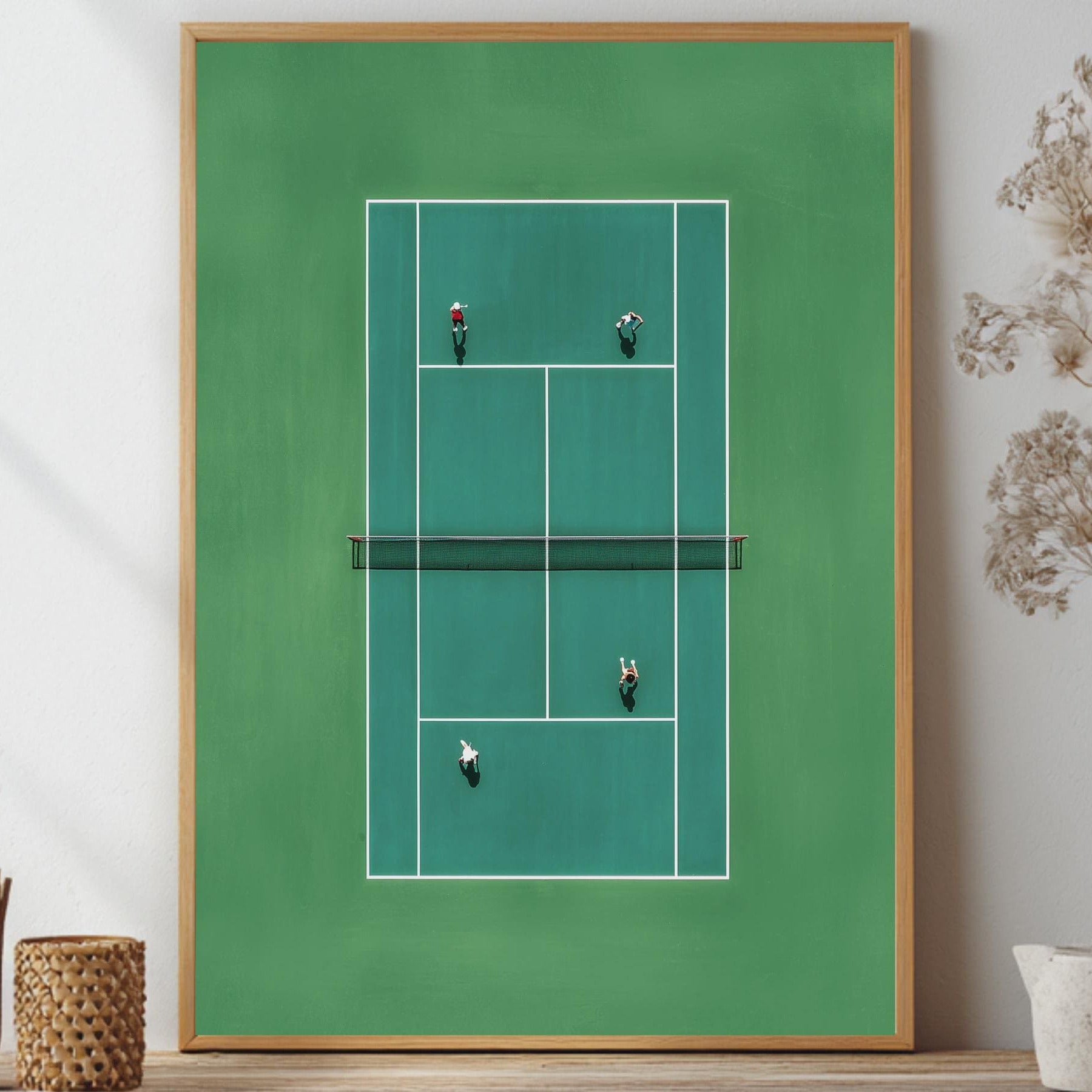 Framed artwork of a tennis court in miniature from above on a wall with decorative elements.