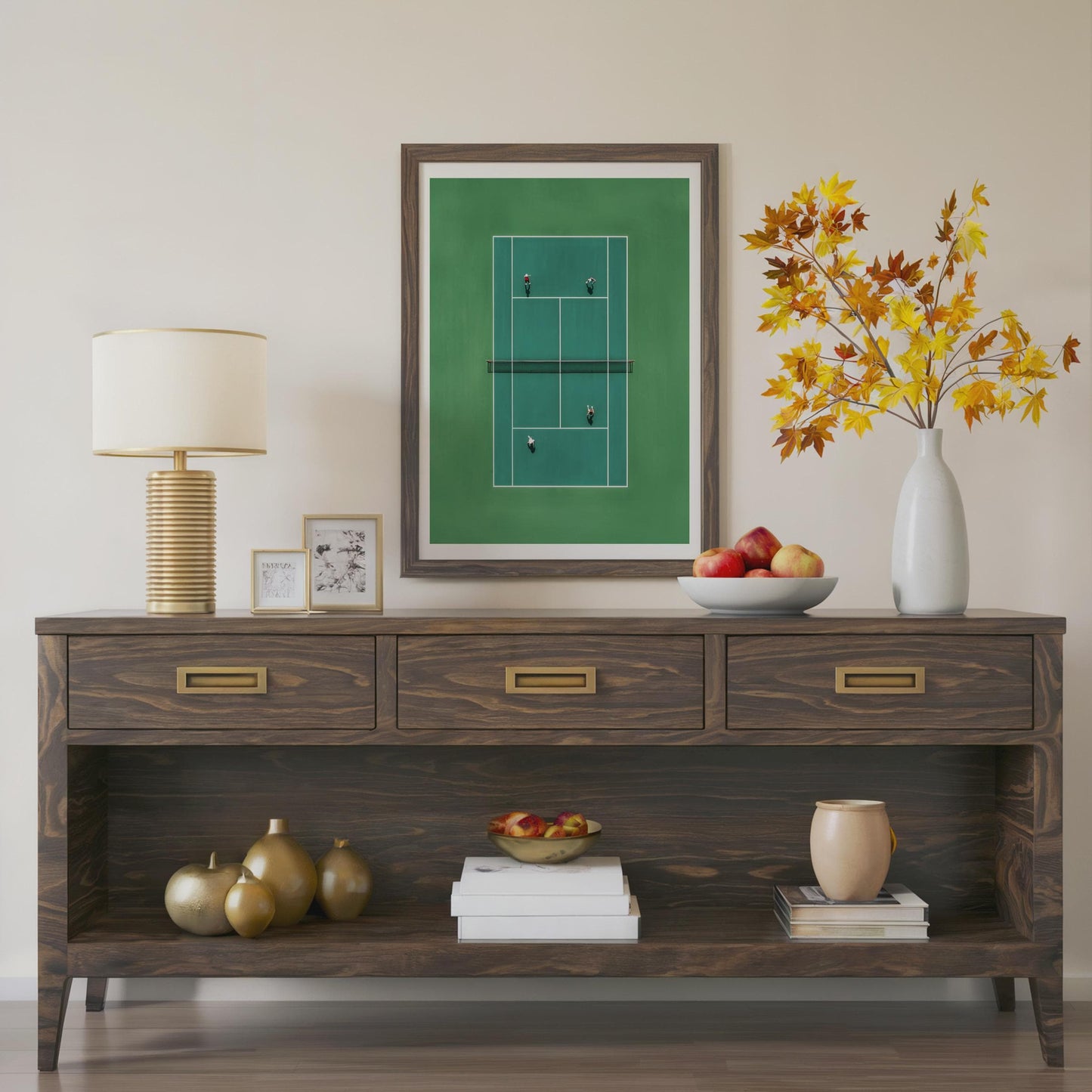 Wooden console table with decorative items including a lamp, framed picture, and vase.Framed artwork of a tennis court in miniature from above 