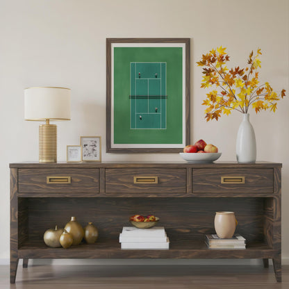 Wooden console table with decorative items including a lamp, framed picture, and vase.Framed artwork of a tennis court in miniature from above 