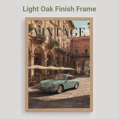 Framed poster with vintage car and building scene, light oak finish frame.Vintage 1950s Porsche 911 classic car poster in a black frame on a white living room wall