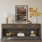 Wooden console table with decorative items including a lamp, framed picture, and vase with flowers.Vintage 1950s Porsche 911 classic car poster in a black frame on a white living room wall