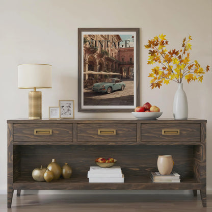 Wooden console table with decorative items including a lamp, framed picture, and vase with flowers.Vintage 1950s Porsche 911 classic car poster in a black frame on a white living room wall